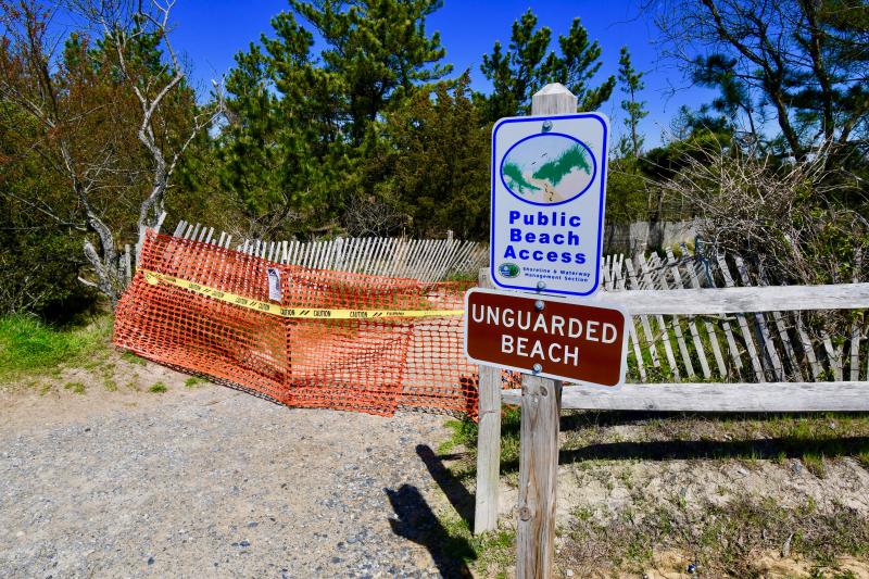 Although beach access is closed at Herring Point in Cape Henlopen State Park, the sign states that people can exercise and walk dogs on the beach.