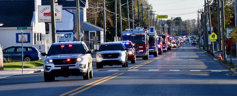 Led by Lewes Police, a long line of first repsonders drive on Savannah Road toward Beebe Healthcare.