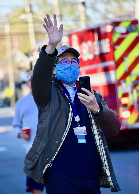 Beebe Healthcare President and CEO David Tam waves to firefighters as they drive by the front of the hospital. RON MACARTHUR PHOTO