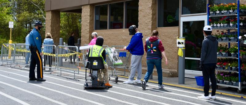 State police and Walmart employees monitor the front door of the Rehoboth Beach store on the first day of mandatory face-covering requirements. RON MACARTHUR PHOTO