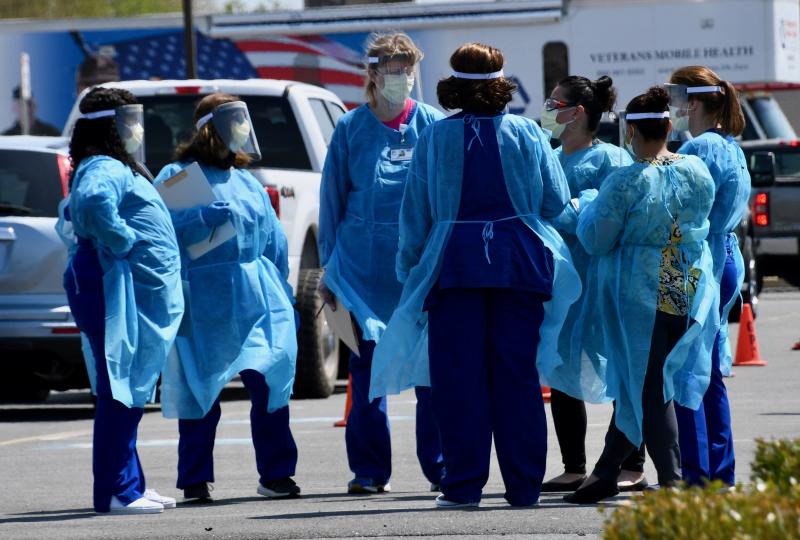 Nurses gather to discuss how the screening and testing process will work during the early stages of the testing event in Georgetown.