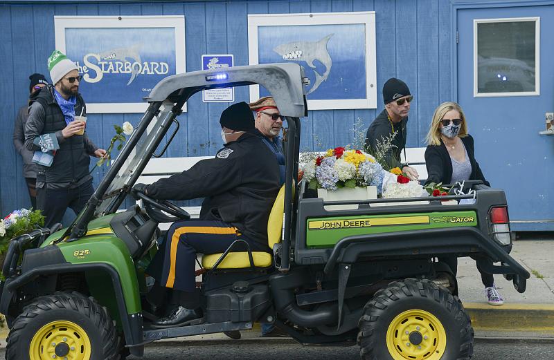 An ATV cruised slowly through town while mourners placed flowers to be delivered to TJ’s gravesite at the conclusion of the private family service and burial.
