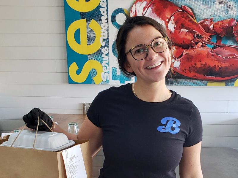 Eleven of SoDel Concepts’ 12 restaurants, including Bluecoast Seafood Grill & Raw Bar in Rehoboth Beach and Bethany Beach, will participate in the April 18 fundraiser to benefit the Beebe Healthcare COVID-19 Relief Fund. Online ordering and payment and contactless curbside pickup are encouraged. Shown with a prepared order is Bluecoast team member Molly Williams. SUBMITTED PHOTOS
