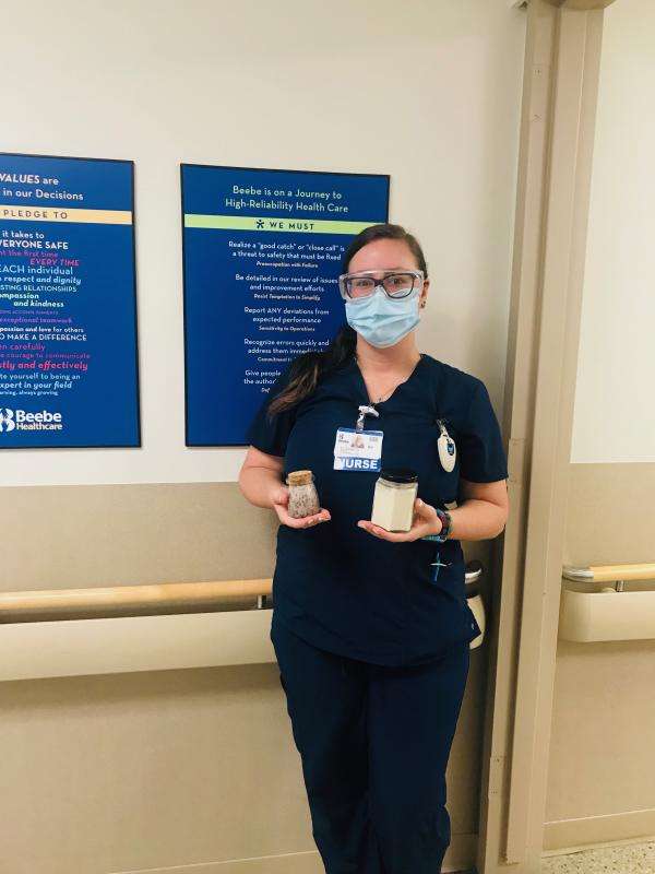 Libby Rendall, RN at Beebe, holds the body scrub and candle included in the Treat Yourself Kit the DAC will be delivering to healthcare providers in May.