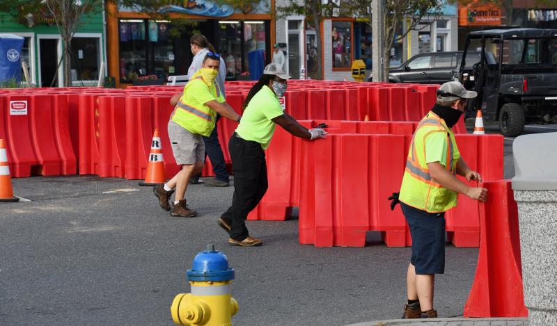 City of Rehoboth Beach workers move barricades across Rehoboth Avenue to block off areas for additional restaurant seating. RON MACARTHUR PHOTO
