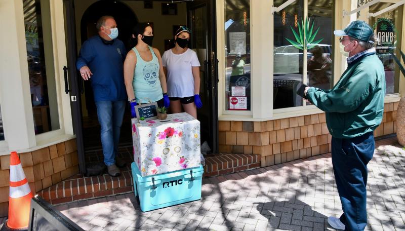 From left, Agave’s Mike Firetti, Kelly Smith and Jocelyn McKeown are ready for customers during the restaurant’s May 4 free burrito day. RON MACARTHUR PHOTO