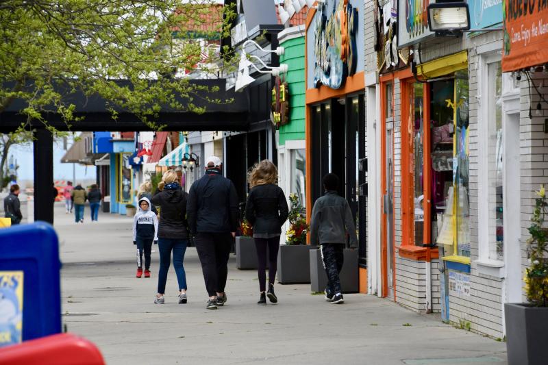 Some people walk along Rehoboth Avenue over the weekend. Foot traffic can be expected to increase dramatically as the beach and Boardwalk reopen Friday, May 15.