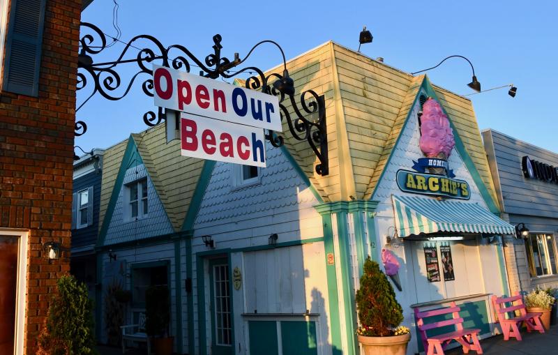 A sign over Penny Lane in downtown Rehoboth Beach shows the anxiety many local business owners are feeling as the state of emergency stretches to two months.