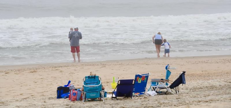 A family enjoys some alone time on the sand of Rehoboth Beach.