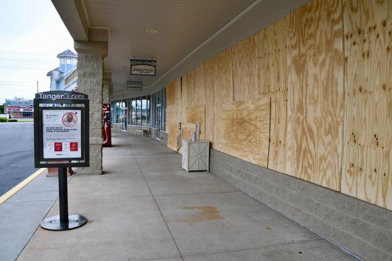 Nautica in Tanger Outlets has its windows boarded up after threats of violence circulated on some Facebook posts.