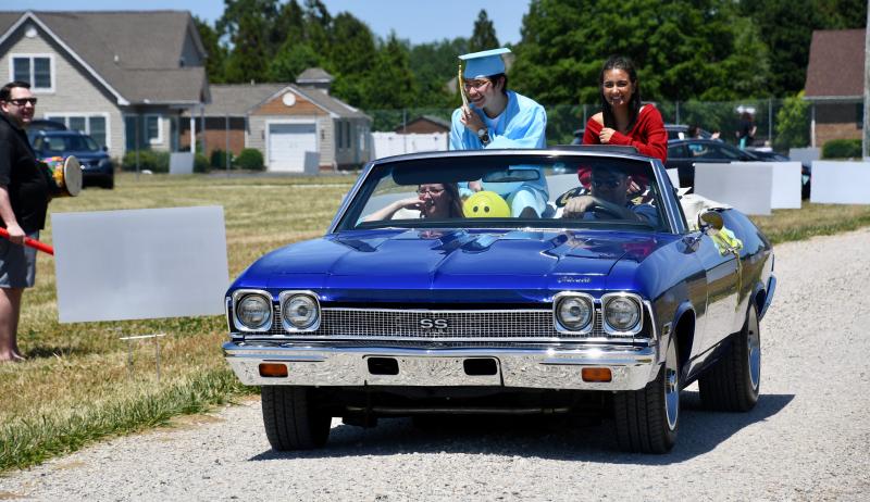 Cape High graduate Myles Mukasa and Alana Sorbie, a member of the Class of 2019, are chauffeured along the route in a vintage Chevelle Super Sport.