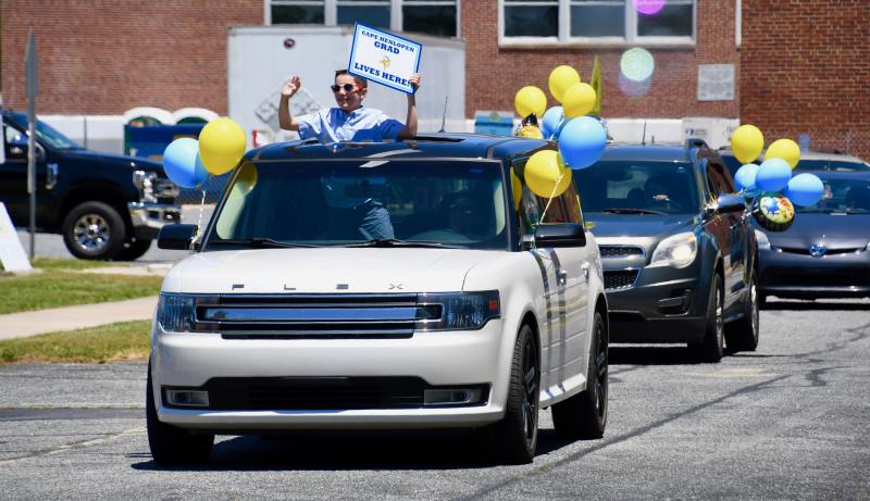 Shields Elementary fifth-grader Conor Haun is all smiles as he rides by school staff. RON MACARTHUR PHOTO