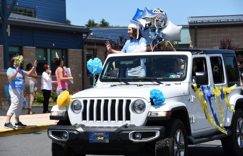 In a decked-out Jeep, student Caiden Juliano waves to Love Creek Elementary staff. RON MACARTHUR PHOTO