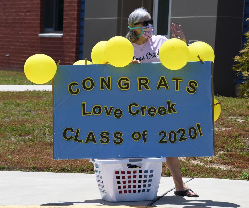Love Creek Elementary paraprofessional Vicky McGowan congratulates the fifth-grade class. RON MACARTHUR PHOTO