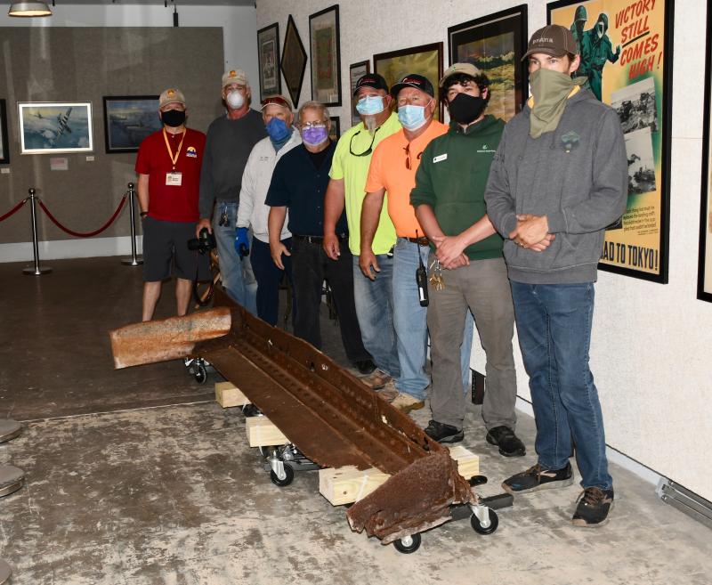Taking part in the move are (l-r) Larry Boyer, FMHA treasurer; Pat Bragdon, FMHA member; Gary Wray, FMHA president; Cliff Geisler, Arizona Task Force chairman; Billy Mitchell and Keven Rains, Corrado Construction; Tyler Dreiblatt, Delaware State Parks Fort Miles interpreter; and Abraxas Hudson, FHMA member.