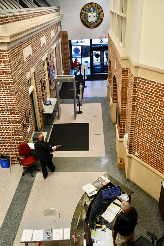 Before passing through the lobby, visitors to the county administration building must pass a health screening complete with remote temperature reading.