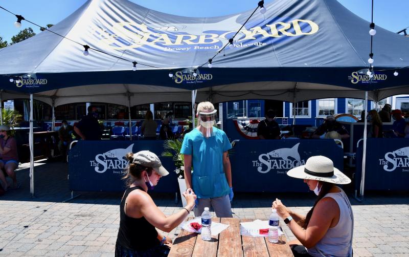 The Starboard, which closed over the weekend to allow employees to get COVID-19 tests, plans to reopen Tuesday, June 30. Administering tests is Raelyn Blevins, a member of the Delaware Air National Guard.