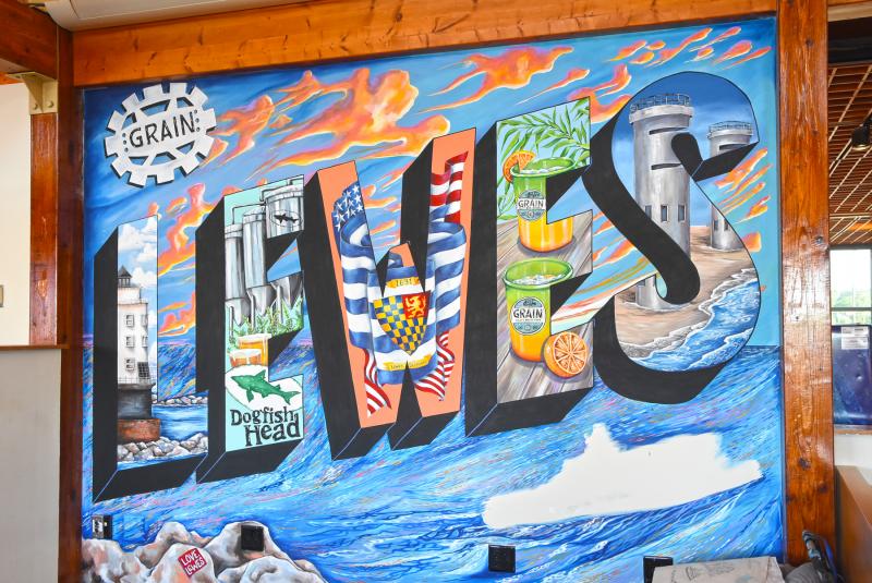 A postcard mural serves as a backdrop for live music. It’s also a perfect place to take photos for social media.