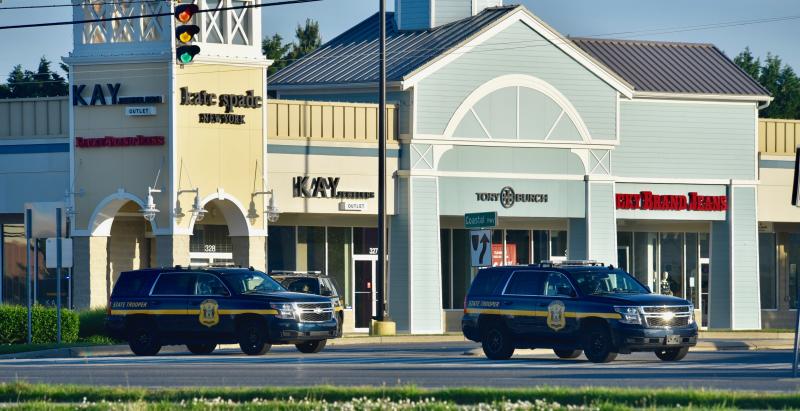 Just a few of the dozens of Delaware State Police troopers block an entrance to Tanger Outlets. At least 40 DSP vehicles were on hand to guard the outlets and other stores along Route 1.