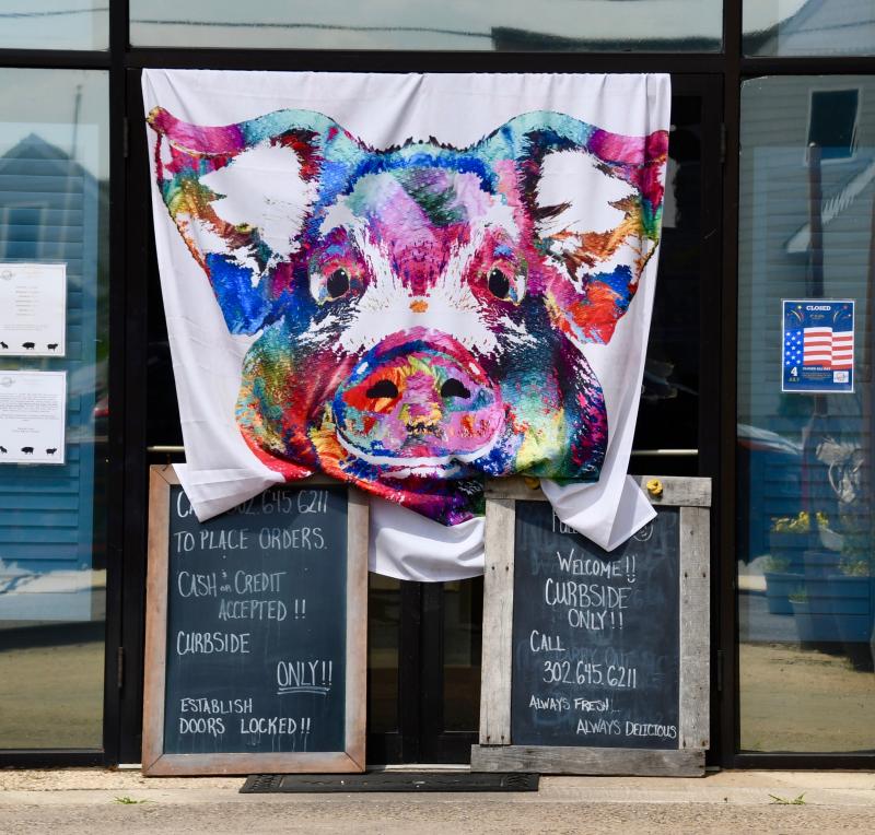 Full Belly Bistro on Wescoats Road, Lewes, has Art-Deco pig art reminding patrons the restaurant is open for carry out only.
