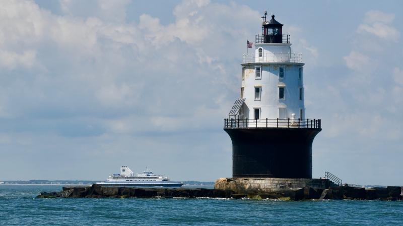 With the Harbor of Refuge Lighthouse in the foreground, the Cape May-Lewes Ferry makes a run to New Jersey. Unfortunately, if Delaware residents make a visit to New Jersey, they will need to self-quarantine for 14 days.