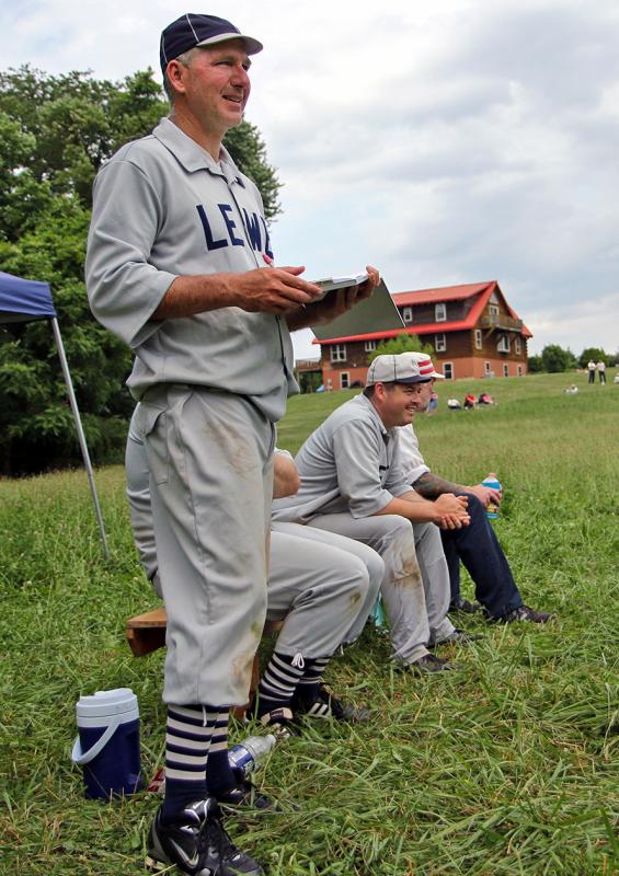 Doug Cooper, left, and Jason Blanshine watch the action from the bench. PHOTO COURTESY OF DENNIS TUTTLE/5EDITORIAL