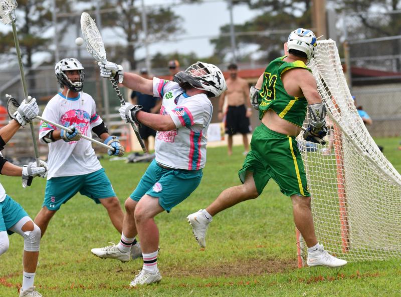 Dogfish Head goalie James Lewis McCleaft, center, makes a save on Lingo’s Dan Deckelbaum in the 5-4 Jack Lingo semifinal win.