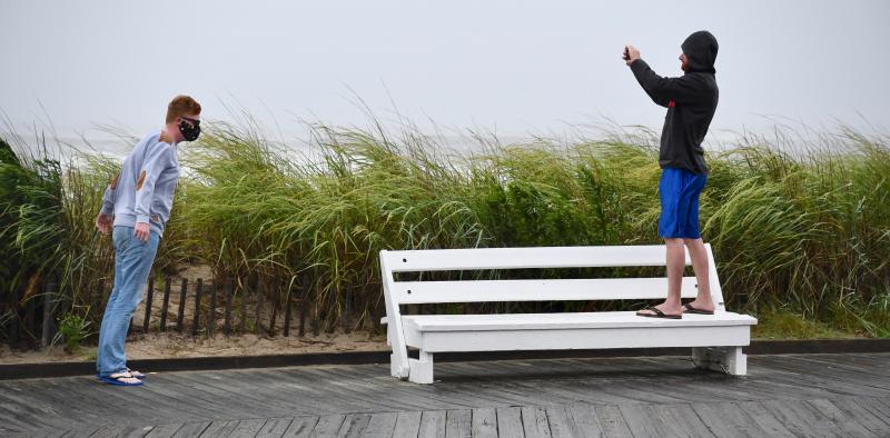 Leaning into the south wind, a friend takes a photograph on the Rehoboth Beach Boardwalk. RON MACARTHUR PHOTO