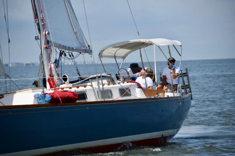 Aboard Iris, skipper Hattie Warwick-Smith keeps an eye on the sails as she and her crew compete in the spinnaker class.
