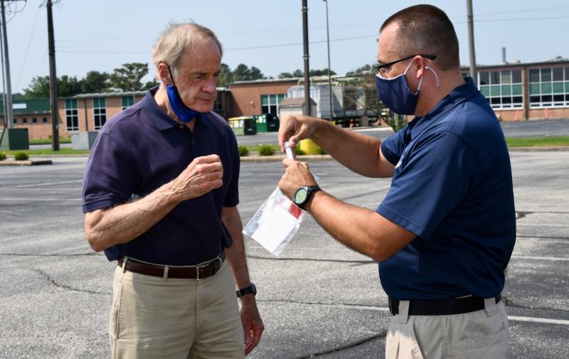 Jeff Sands, DEMA community relations coordinator, takes Sen. Tom Carper’s sample to be sent to a lab. Throughout the state, results can be expected in 48 to 72 hours, Sands said.