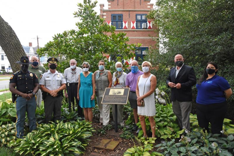 Surrounding the memorial plaque in Lewes’ Zwaanendael Park are (l-r) Milton Police Chief Derrick Harvey, Eric Williams of Delaware State Police Federal Credit Union, Lewes Police Chief Tom Spell, Bill and Ellen Graves, JR Futcher, JuneRose Futcher, Sussex County Councilman Doug Hudson, Rep. Ruth Briggs King, Speaker of the House Rep. Pete Schwartzkopf and Lauren Irby of Delaware Electric Cooperative. NICK ROTH PHOTO