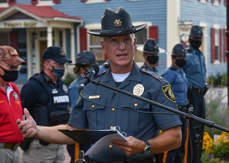 Georgetown Police Chief R.L. Hughes speaks to the 200 people gathered on The Circle in Georgetown to honor Patrolman Chad Spicer’s memory.