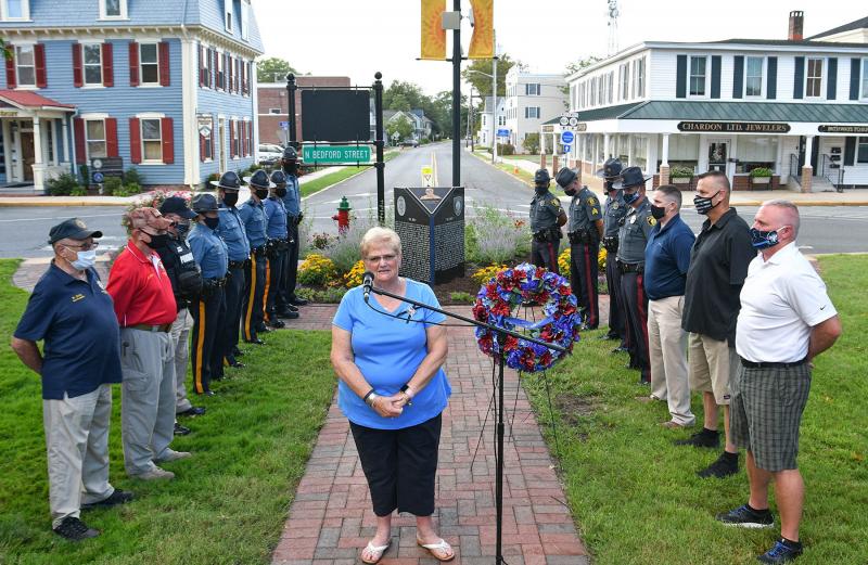 Chad Spicer’s mother Ruth Ann speaks, surrounded by the many officers in attendance at the ceremony.