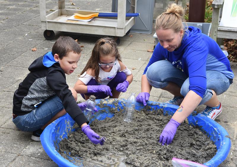 Making Winogradsky columns at Coast Day 2019 are (l-r) Braydon Cox, 8, of Lewes; Kyla Flowers, 5, of Manheim, Pa.; and Sabrina Beckmann. NICK ROTH PHOTO
