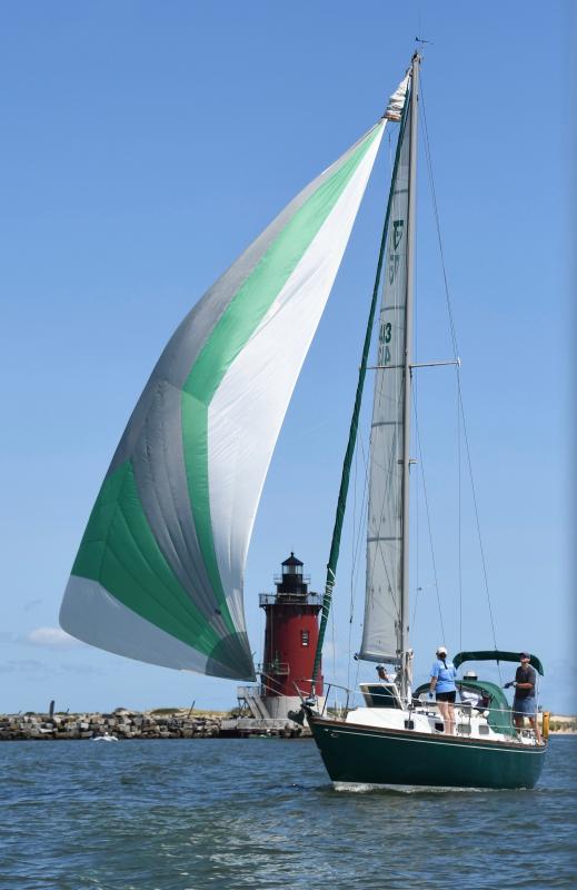 With its green spinnaker flying, Osprey, skippered by John Biddle, heads toward a second-place finish.