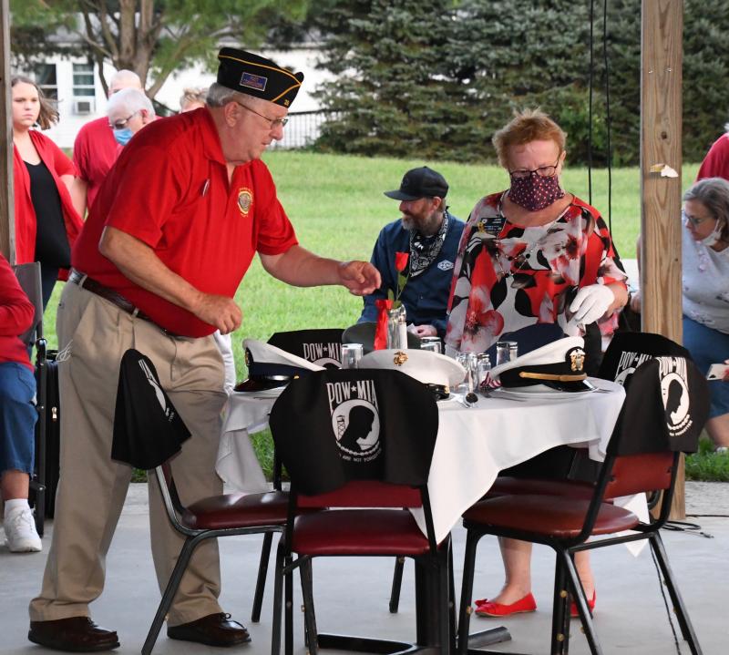 Lee Glasco, left, Post 28 past commander, and June Jones, American Legion Auxiliary vice president, prepare the table in honor of prisoners and war and those missing in action.