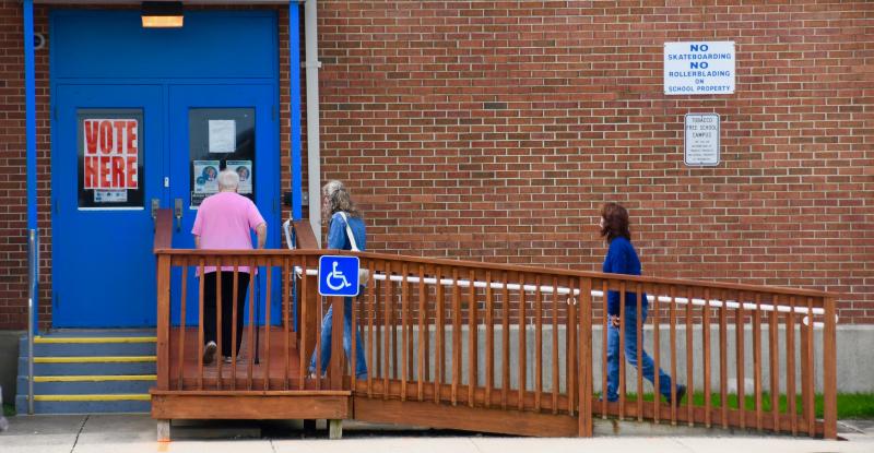 Voters walk up the ramp to get into Richard Shields Elementary School, one of two polling places inside Lewes city limits.