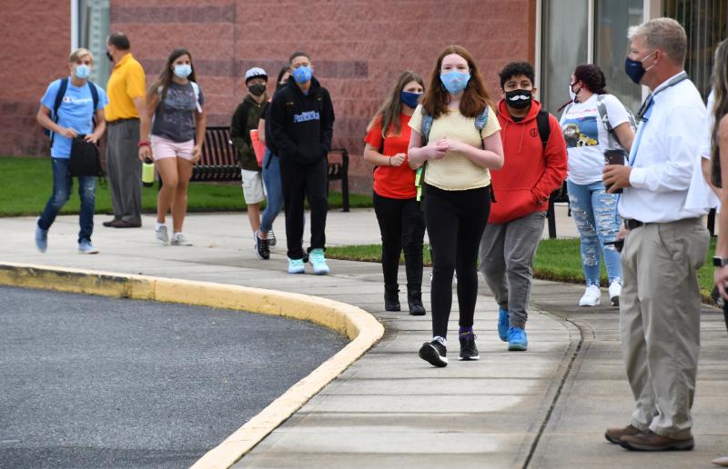Under the watchful eye of principal Dave Frederick, students prepare to enter Beacon Middle School Sept. 17, the first day for Cape Henlopen district middle school and high school students.