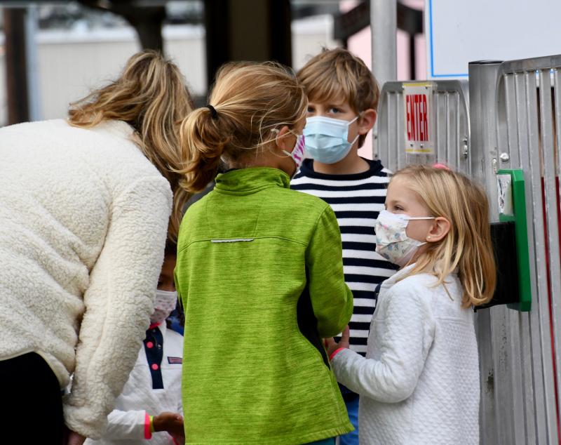 A family gathers near a sanitation station before going on the Freefall ride at Funland in Rehoboth Beach.