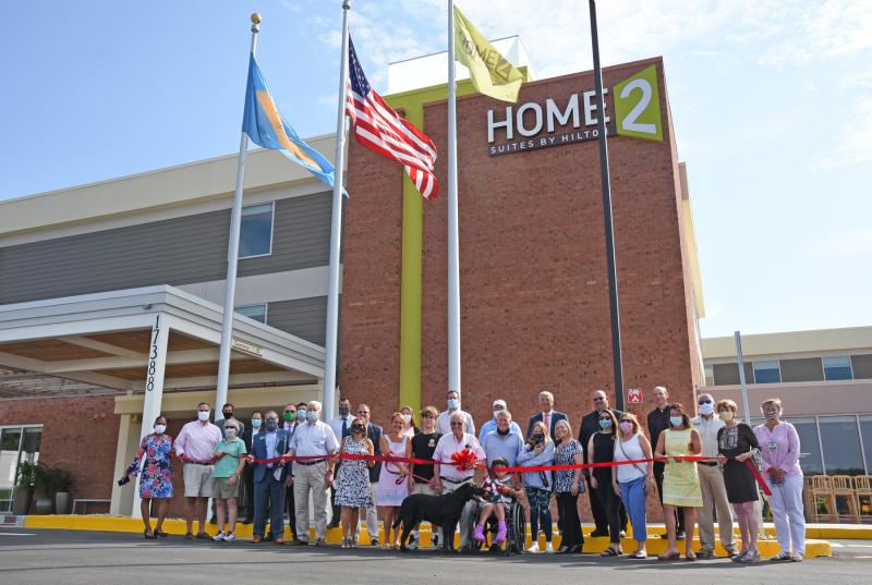 The Caggiano family cuts the ribbon on their new hotel in Lewes. Among those in the photo are Nick Caggiano Sr., Nick Caggiano Jr., Andrea Caggiano, Vincent Caggiano, Camille Caggiano, Julia Caggiano, Bear and Coco Caggiano, Lewes Mayor Ted Becker, Sen. Ernie Lopez, R-Lewes, State Auditor Kathy McGuiness, Lewes Councilwoman Bonnie Osler, Lewes Chamber board President Nikki Fisher, Lewes Chamber Executive Director Betsy Reamer, Father William Cocco and Father John Olson of St. Edmond Catholic Church and other friends, family and staff of Home2 Suites by Hilton. NICK ROTH PHOTOS
