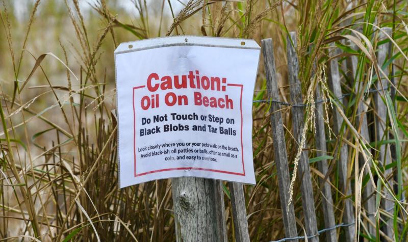 An oil spill, which originated off Broadkill Beach, has spread all the way to Ocean City, Md. Tar balls and globs on the sand are being cleaned up by a crew of 100 from various agencies and contractors. The source of the spill in the Delaware Bay has yet to be determined.