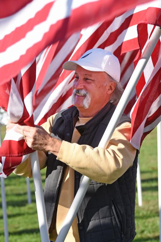 Gerry Smith unravels a flag.