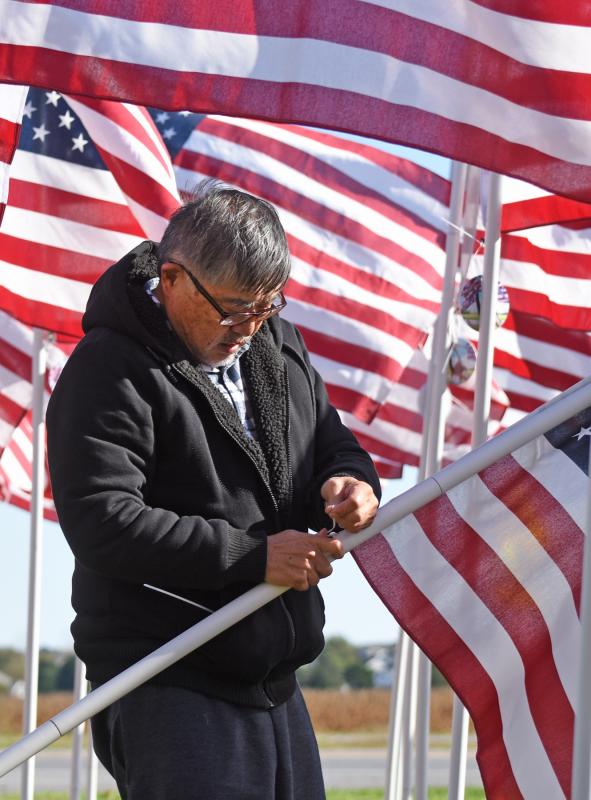John Li makes sure the flag is secured properly.