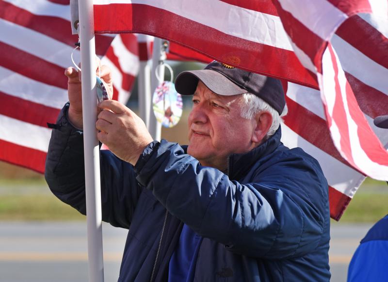 Dave Keller makes sure the medallion is secured to the flag.