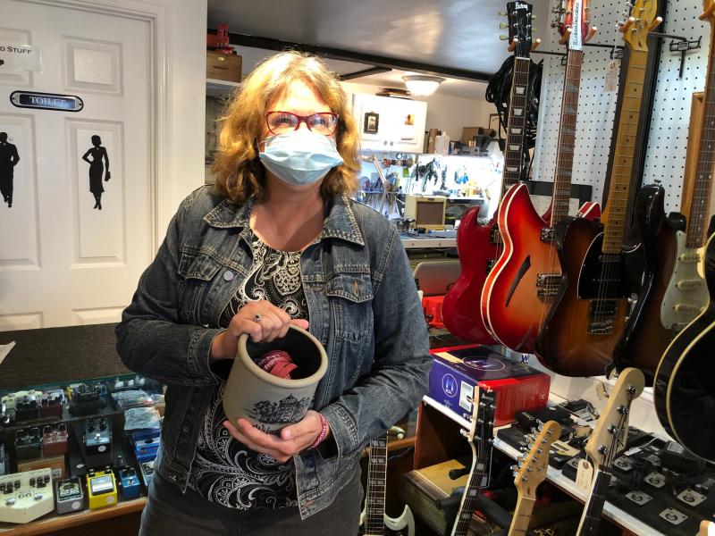 Mary Knight, co-owner of Frantic Frets, shows off the business’ trinket offering of customized wristbands. RYAN MAVITY PHOTO