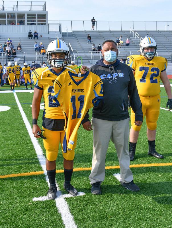 Cape captain Jaden Davis and head coach J.D. Maull carry Jack McPike’s jersey as the honorary captain.