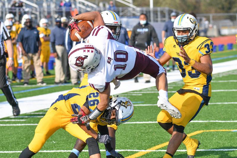 Cape’s Thomas Messick makes a submarine tackle on Caravel’s Ethan Vannarath-Gray at the one-yard line.