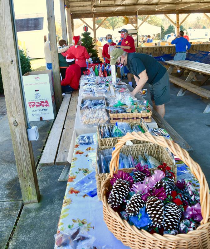 Volunteers greet those attending the kickoff event. Sales of masks, mystery gift bags and baked goods helped raise money for the campaign.