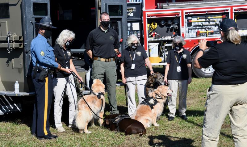 Tri-State Canine Response Team dogs and their handlers pose for a photograph with members of Delaware State Police.