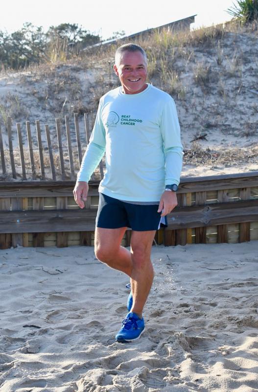 Peter Halper is all smiles as he touches the sand on the East Coast after starting his run four months ago along the Pacific Ocean shoreline.